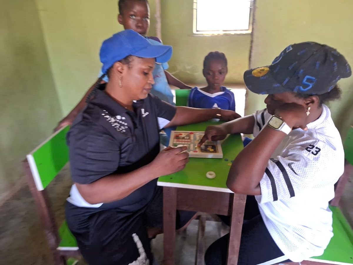 Pupils playing chess at Hills-Grace Schools