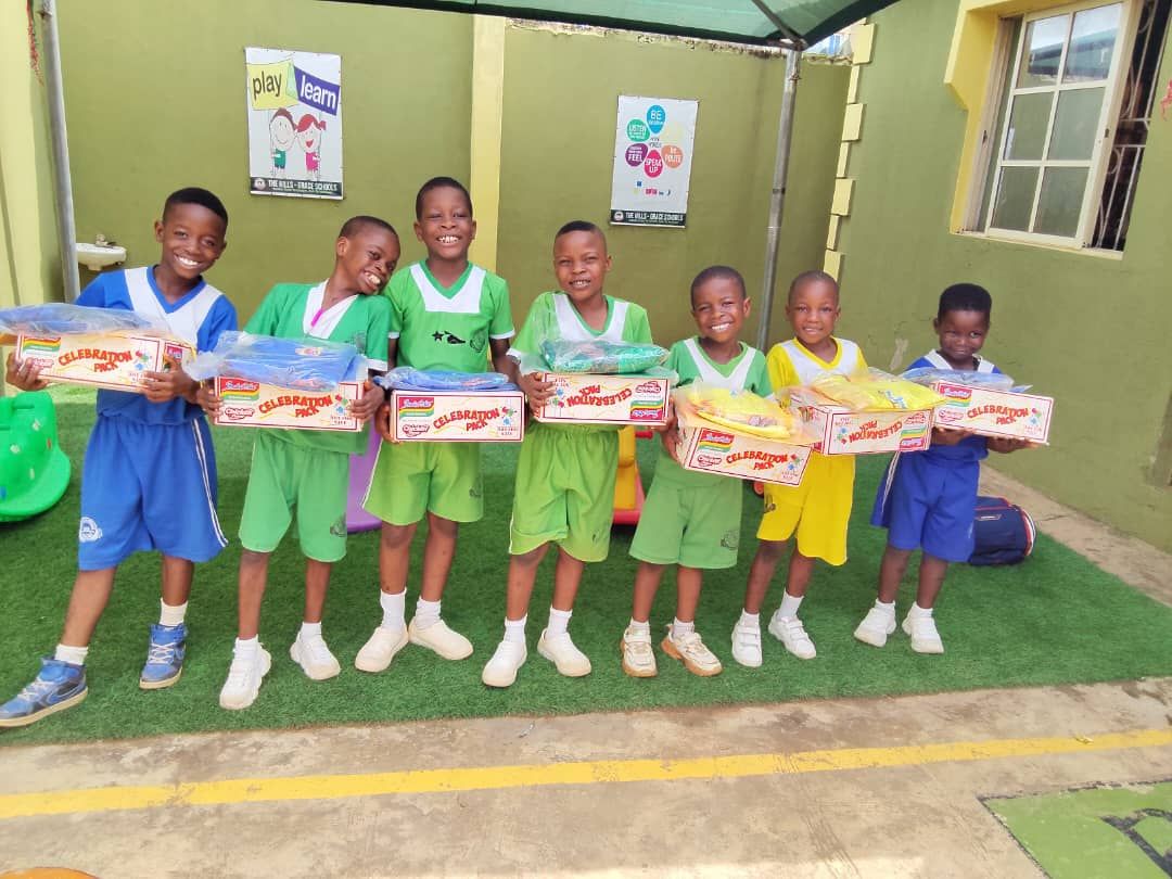 Pupils holding posters at a Hills-Grace Schools competition